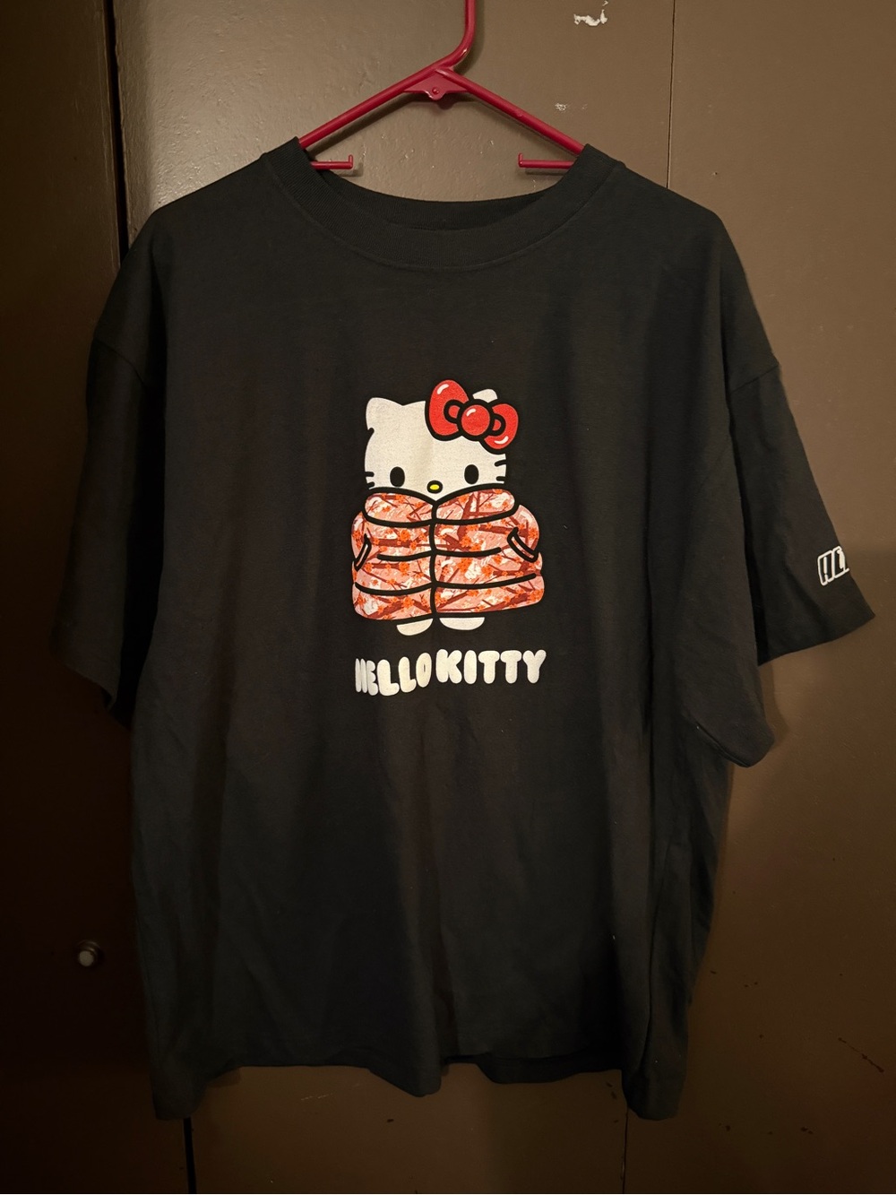 Hello Kitty Black Tee with Red Bow and Orange Patterned Jacket Graphic